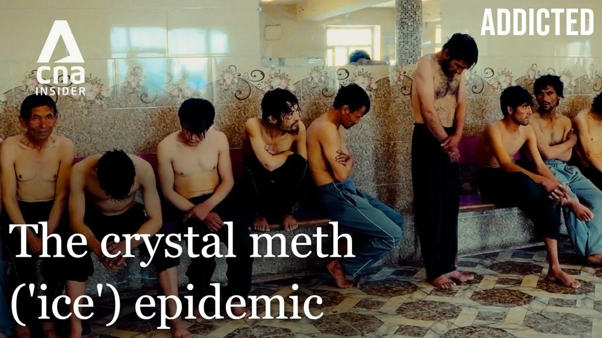 A group of shirtless men sit and stand in a tiled room, showing a somber mood. Text overlay reads: "The crystal meth ('ice') epidemic." Addicted logo in the top right corner and CNA Insider logo in the top left corner.