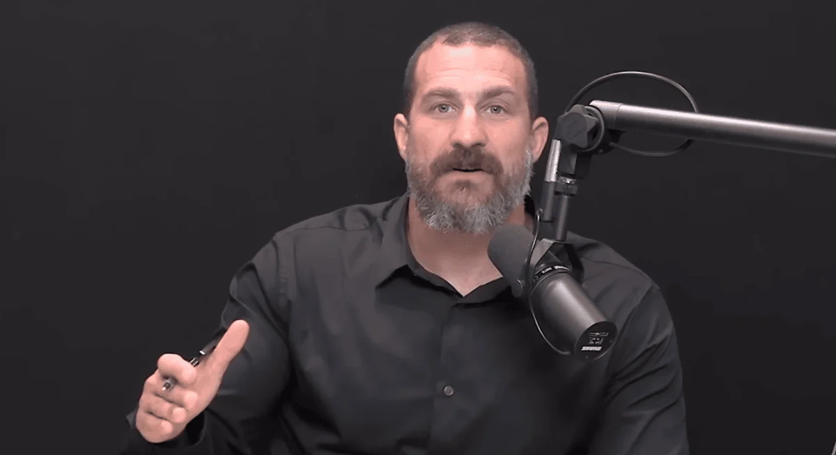 Dr. Andrew Huberman - Alcohol & Your Health Dr. Andrew Huberman, a bearded man in a black shirt, speaks into a black microphone against a dark background.