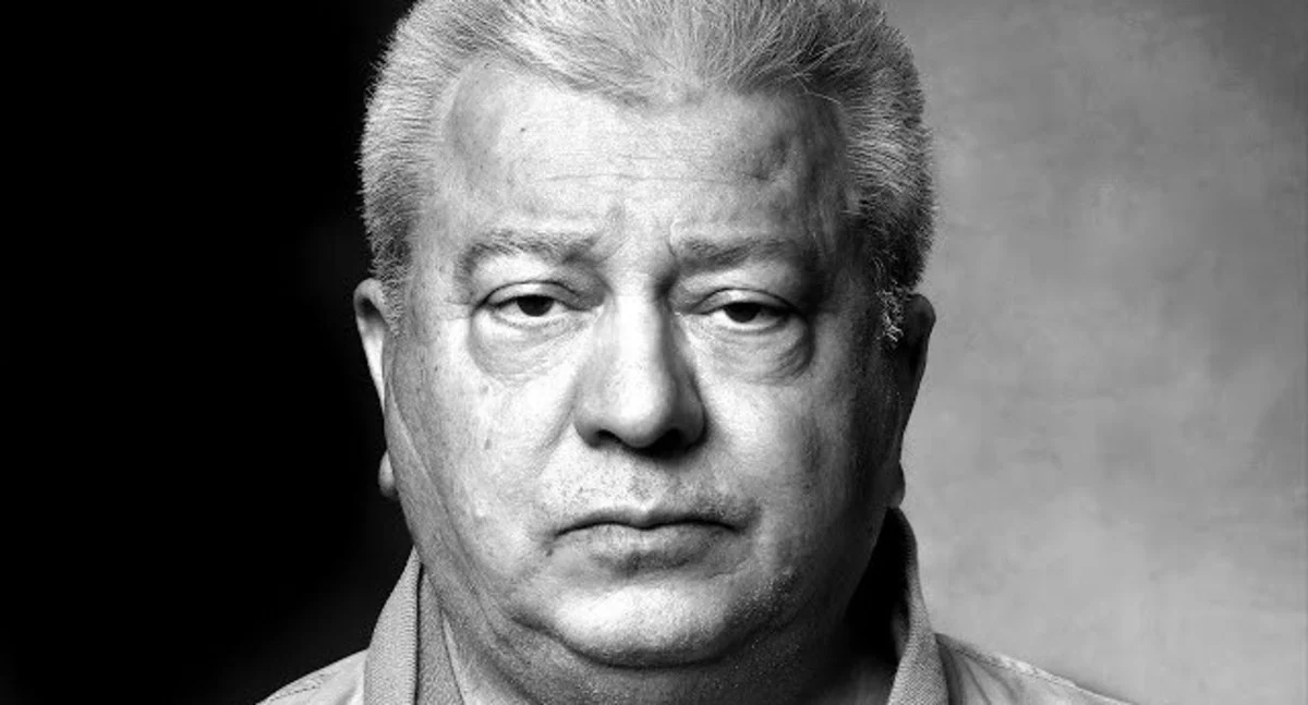 Black and white headshot photo of Archie Karas