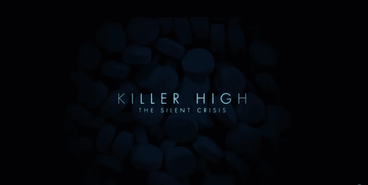 Dark image with scattered pills as the background. Centered text reads "Killer High: The Silent Crisis" in light blue.