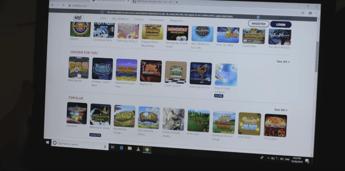 A laptop screen displaying an online casino website with various slot game options, including categories like "Chosen For You" and "Popular."