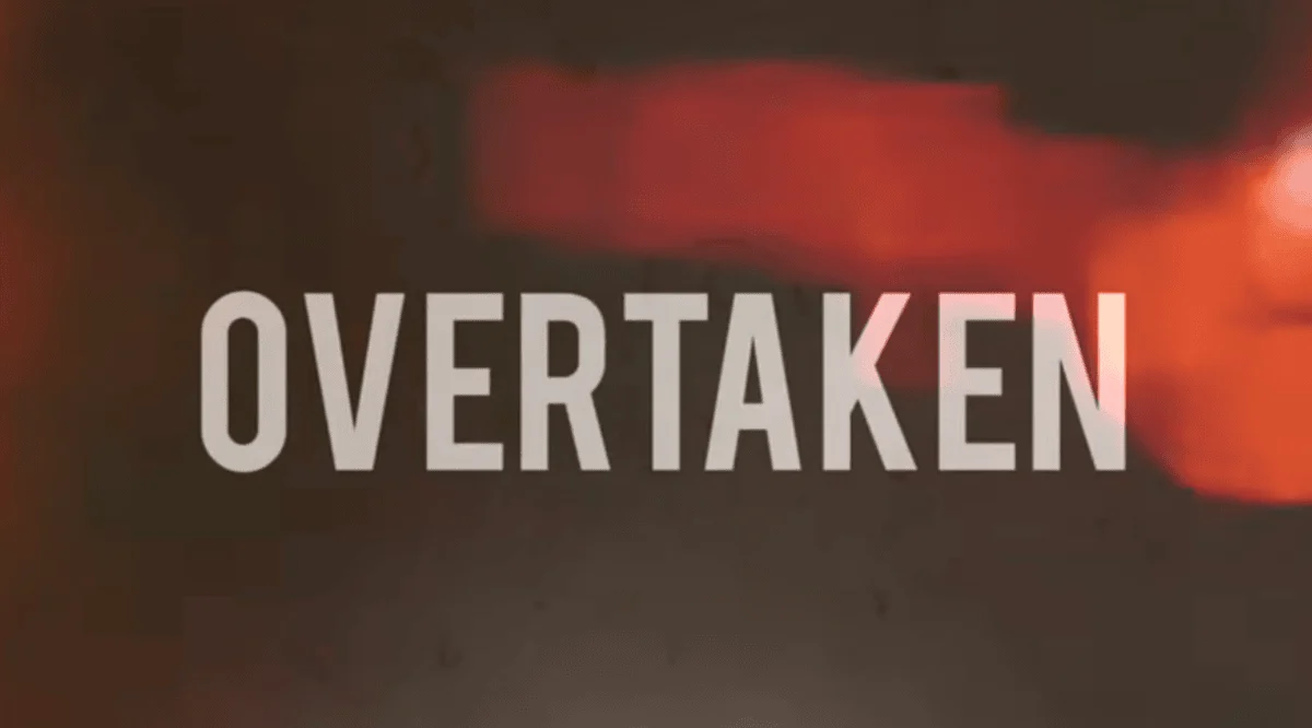 A blurred, dark background with abstract red lights features the bold, white word "OVERTAKEN" in the center, creating a dramatic and intense tone.