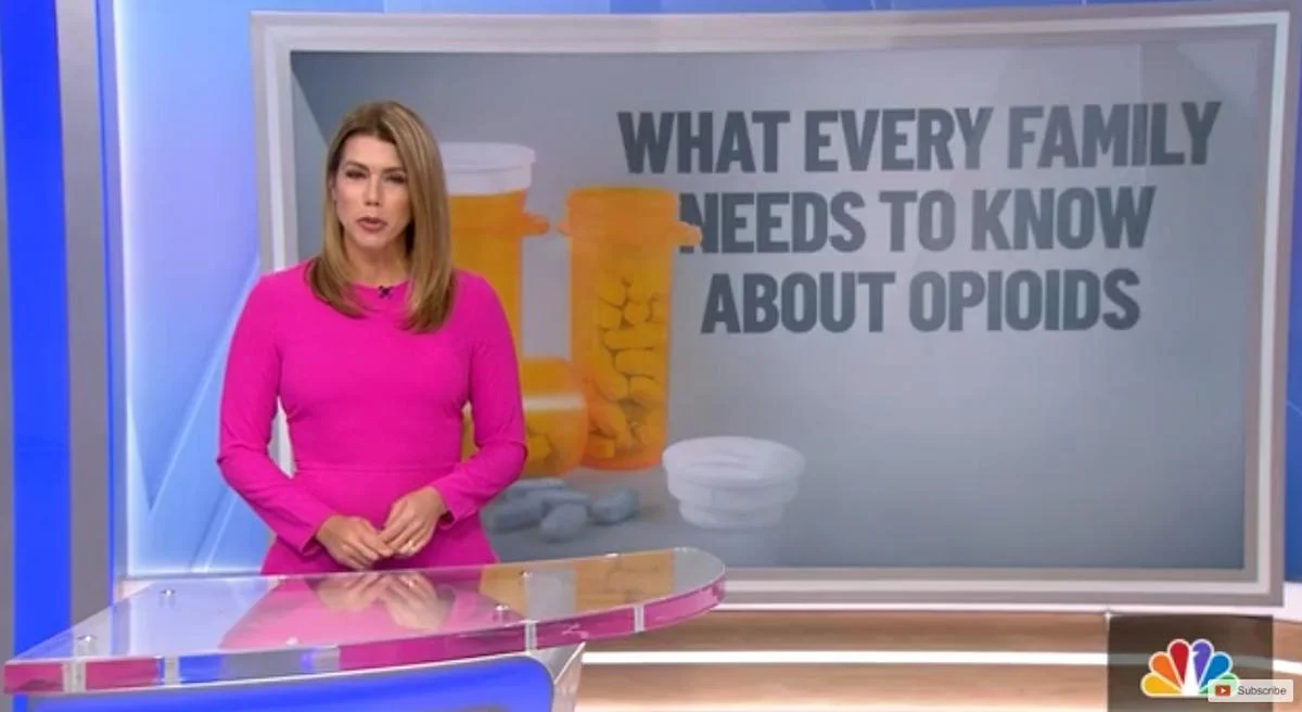 State of Addiction cover featuring a news anchor in a pink dress stands beside a screen displaying pill bottles and the text "What Every Family Needs to Know About Opioids."
