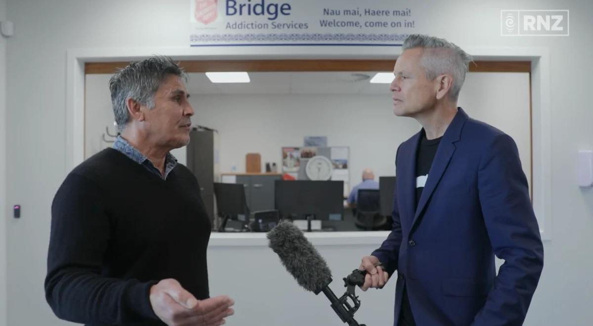 Guyon Espiner interviewing Richard Dick from the Salvation Army in front of the receptionist desk.